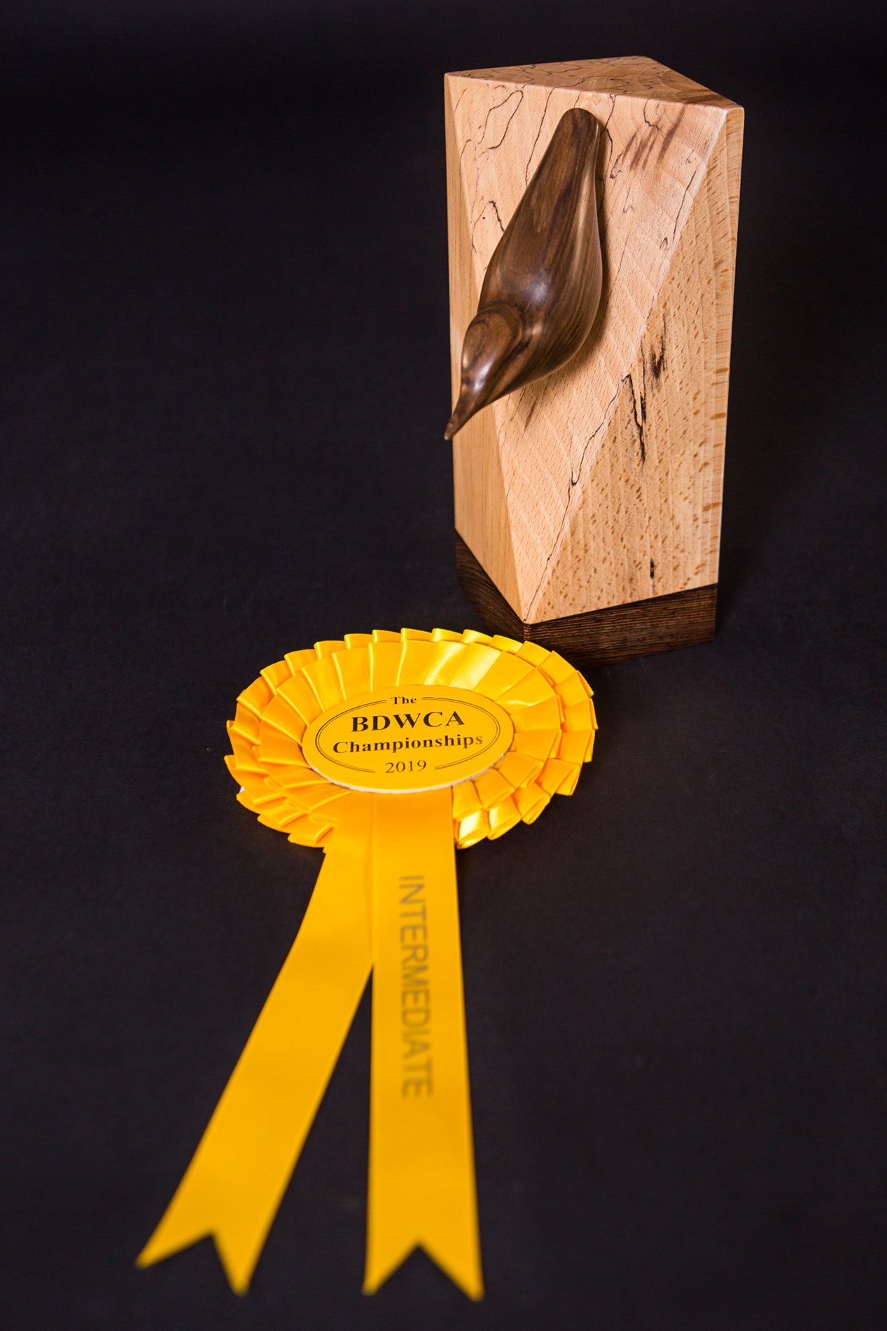 Nuthatch in walnut on spalted beech base by Yvonne Langford