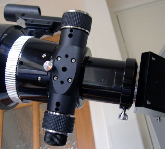 The underside of the focuser, showing the coars and fine focus knobs, hole for the recessed tension adjuster, and the locking collet against the body of the tube assembly.