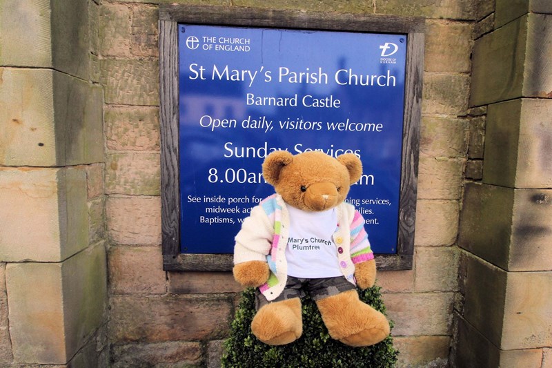 Big Ted by a church sign