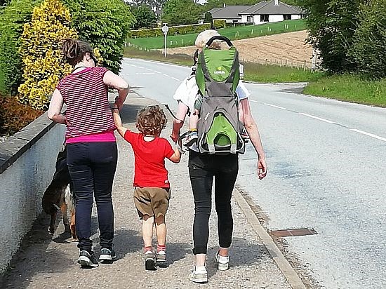 Family walking through  village