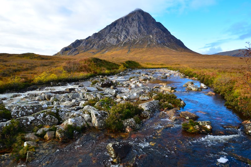 Iconic Buachaille Etive Mor rising above the river Coe in the sunshine