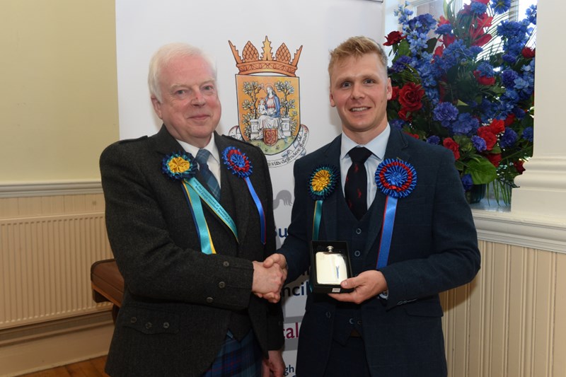 Royal Burgh Standard Bearer 2025 Darren Knox being presented with the traditional hipflask