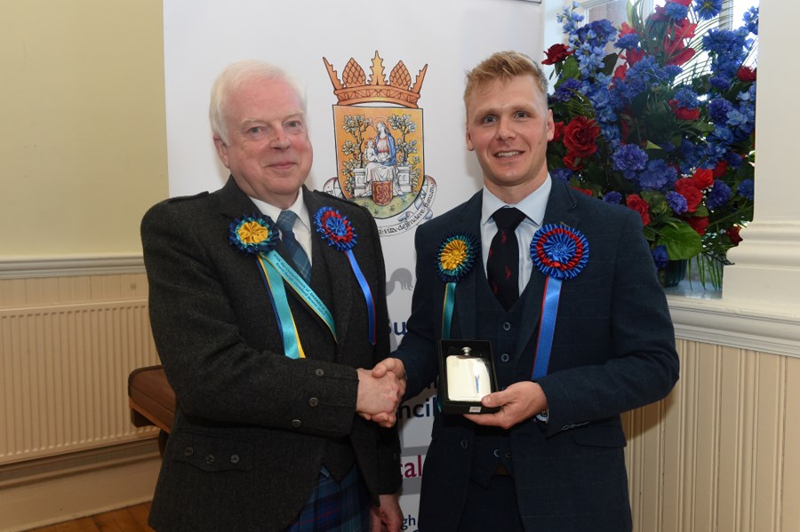 Royal Burgh Standard Bearer 2025 Darren Knox being presented with the traditional hipflask