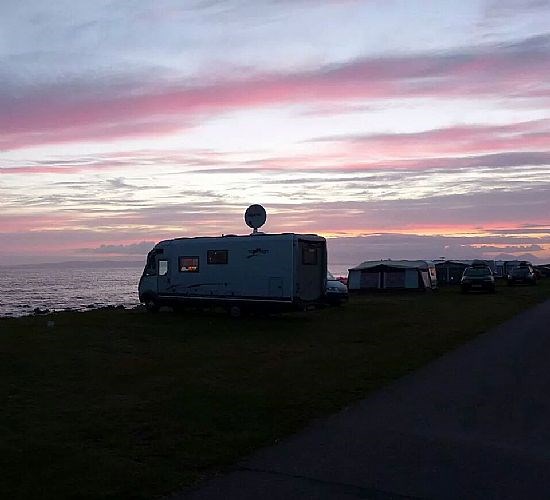 The sun sets over the site