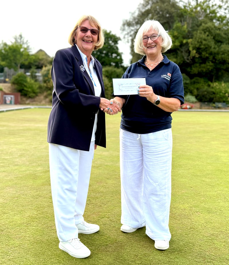 Ronnie Hall from Eastbourne RNLI receiving a cheque for £650 from June's Lifeboat Triples Day