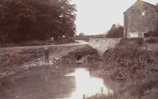 The figure in this photograph is standing at the spot where the car plunged into the mill race.