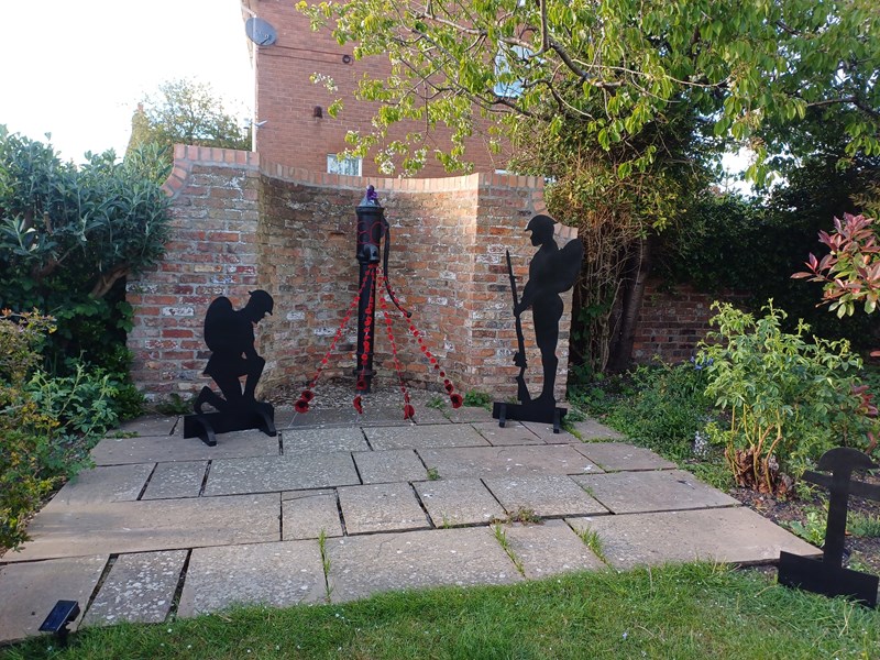 Millennium garden decorated with strings of poppies and soldier silhouttes