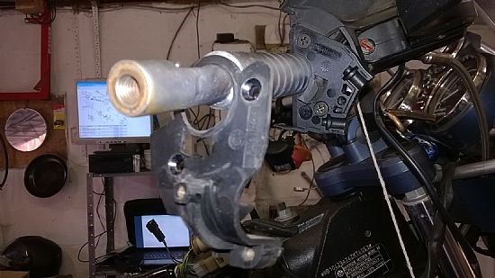 The new type throttle casing fitted with the old one hanging on the bars