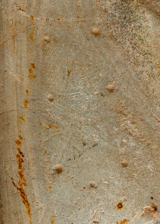 Part of a Neolithic stone axe showing a number of small depressions on the stone face