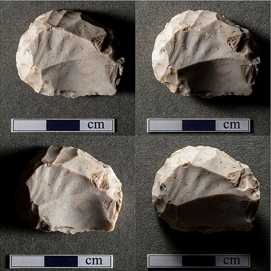 Four differently lit views of the same flint disc scraper