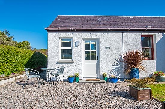 Outside view of a small, white-painted cottage