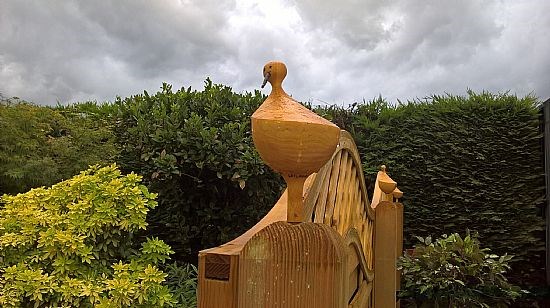 Leylandii garden fence post with a little bird.