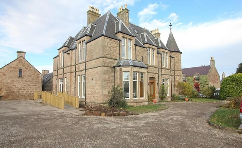 Large sandstone house with turret