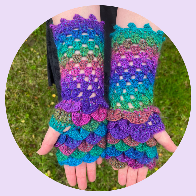 Crocheted Dragonscale gloves in a sparkly rainbow yarn 