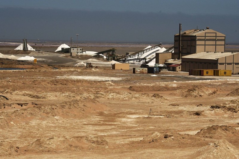 View of Saltworks in desert landscape with piles of white salt