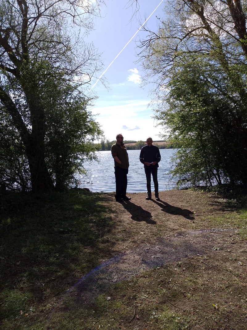 Two people admiring the view across the lake