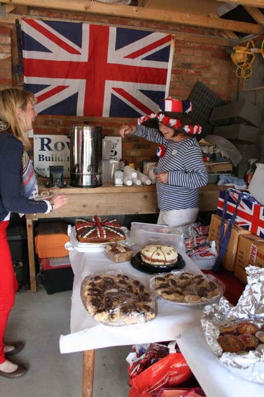 Sue Tanner in full Jubilee swing, surrounded by some of the wonderful cakes.