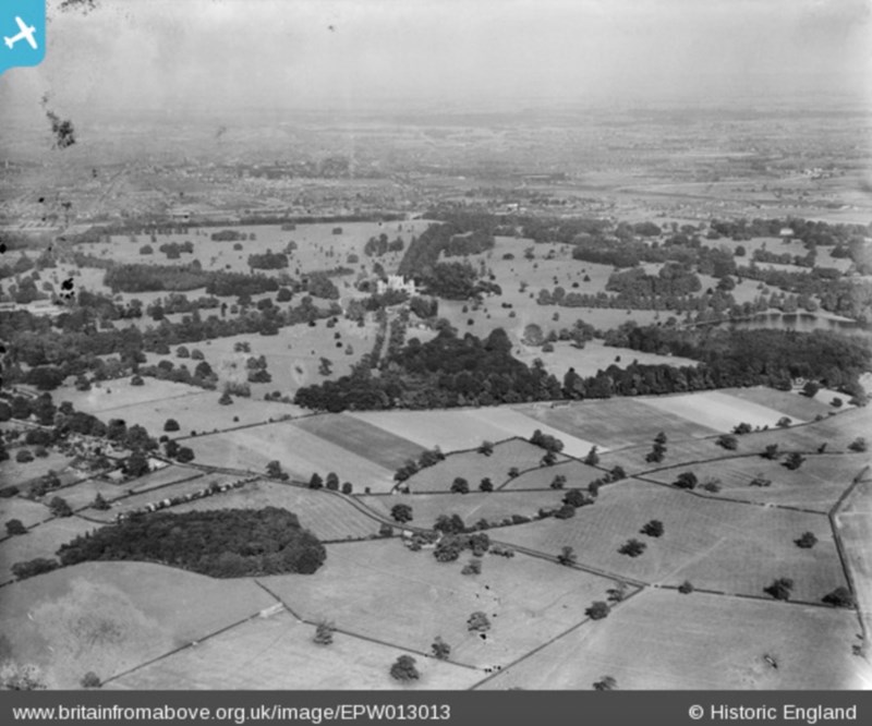 A black and white aerial shot looking over Wollaton Park in the direction of Nottingham City Centre