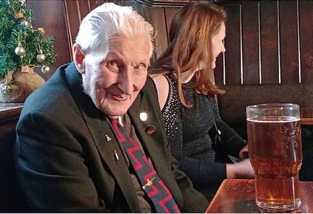 A picture of the author sat with a pint in the pub