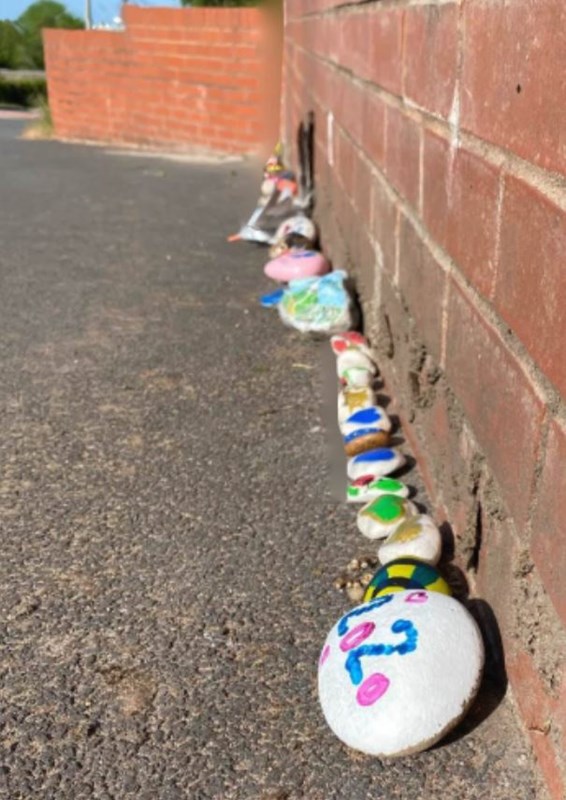 A line of stone pictures at the Ruthin Road layby