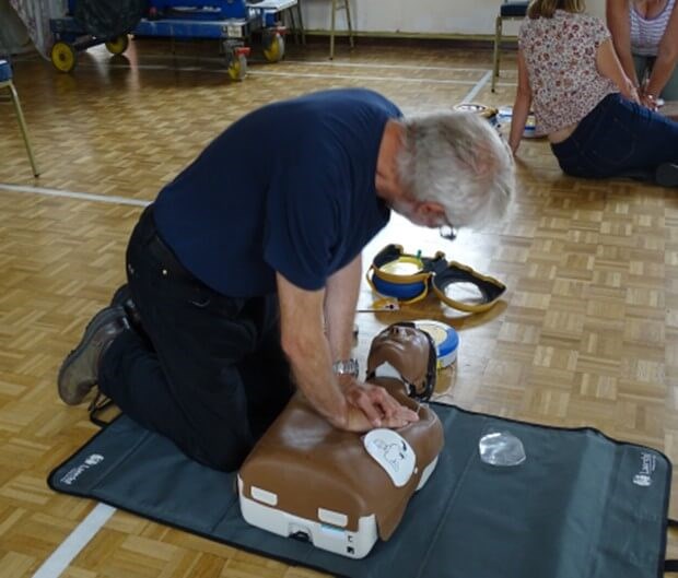 Person giving CPR to a dummy