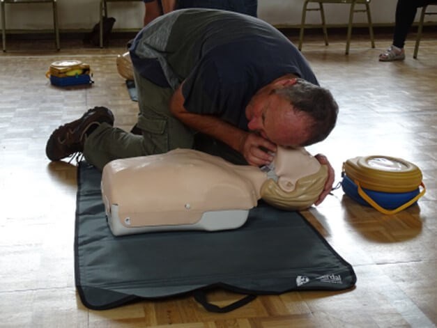 Person giving CPR to a dummy