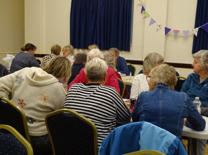 People sitting at tables playing bingo