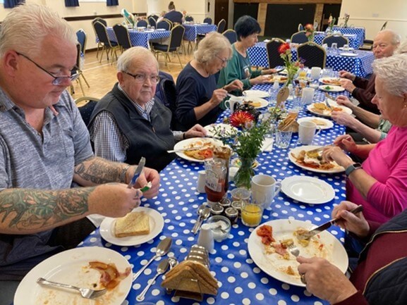 People sitting at a table eating breakfast