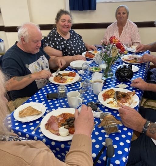 People sitting at a table eating breakfast