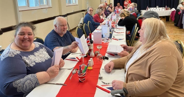 People sitting at tables eating lunch