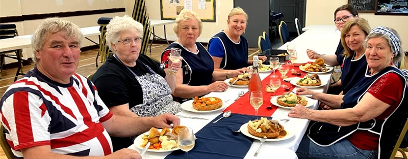 People sitting at table eating lunch