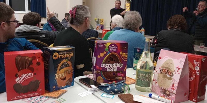 Prizes in the foreground, people playing bingo in the background