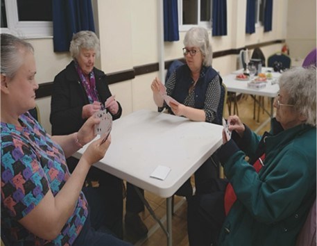 People sitting at table playing cards