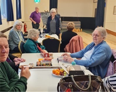 People sitting at a table waiting for cake