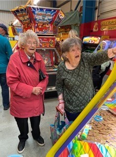 Women playing a coin machine