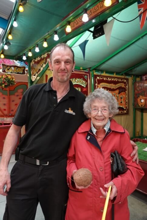 Two people standing and smiling at the camera