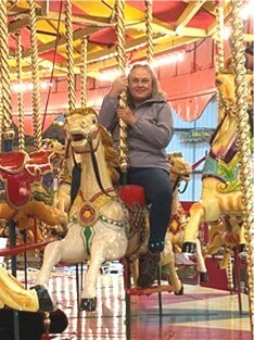 Person riding on a horse on the carousel