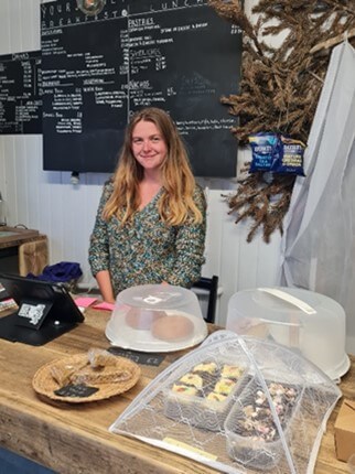 Person behind the cake counter