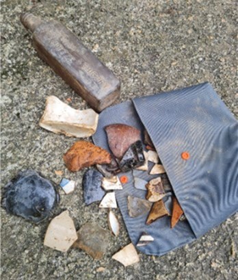 Broken pottery and a glass bottle