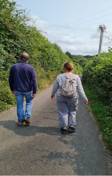 Two people walking on a path