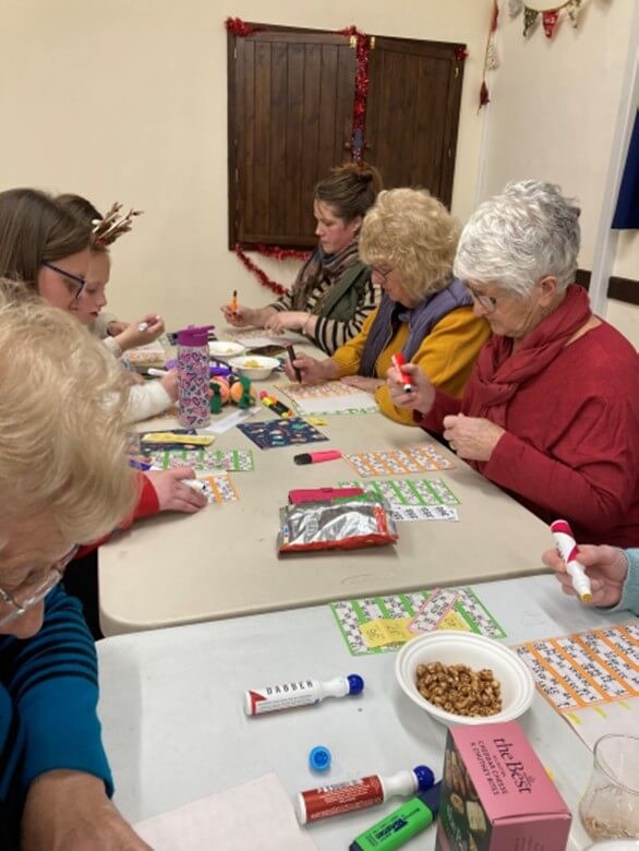 People sitting at a table playing bingo