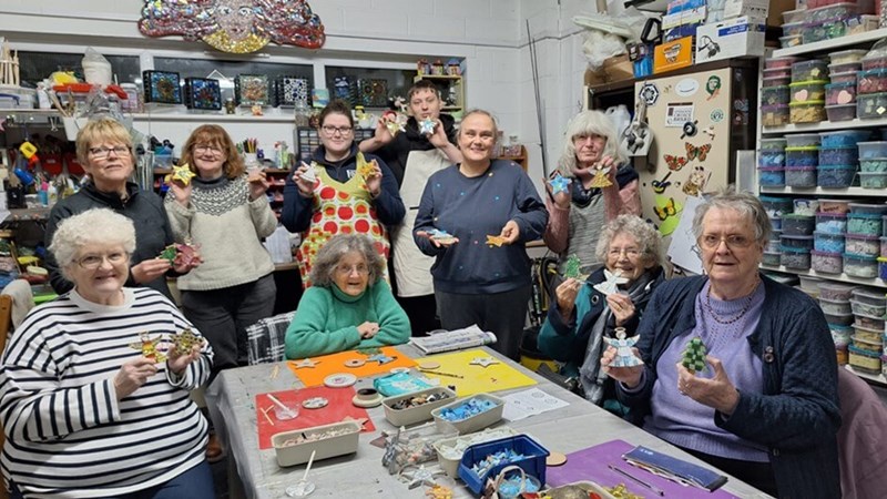 Launcells ladies holding up their Christmas decorations