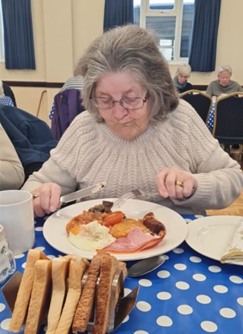 Person eating a fried breakfast