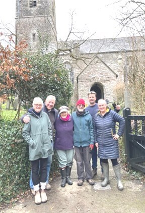 People standing outside the church and smiling at the camera