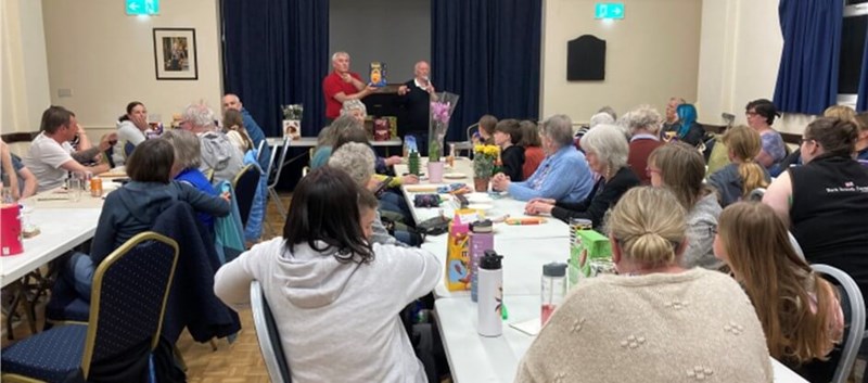 Lots of people sitting at tables playing bingo