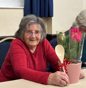 Mary with wooden spoon and raffle prize