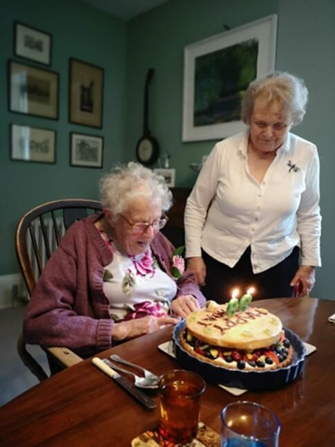 Patricia looking at her birthday cake