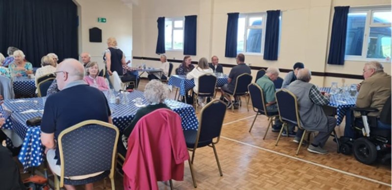 People sitting at tables and eating