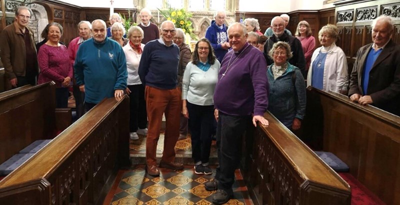 People srtanding at church looking towards the camera