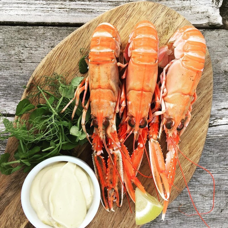 Langoustines served on a board with garlic mayonnaise